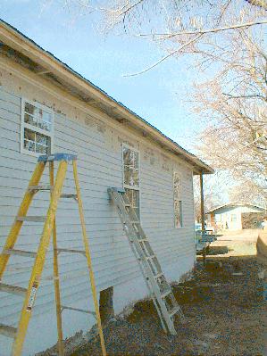 New siding goes up over new drywall. 12/16/98
