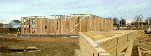 A panorama of community center framing, while roof peaks take shape nearby. 1/12/99