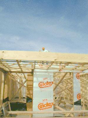 Workmen begin attaching roof supports. 1/15/99
