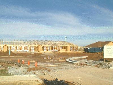 Longer view of second building shows roof peaks now in place. 2/3/99